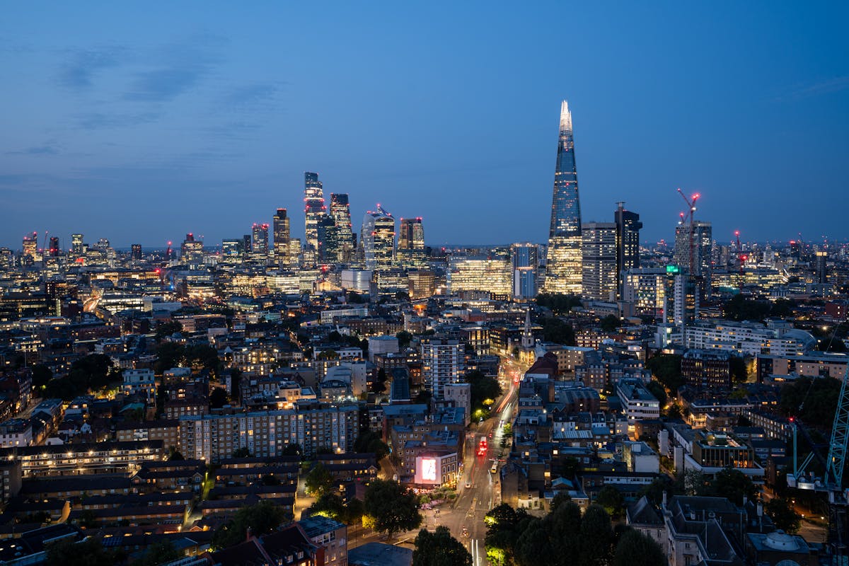 London skyline illuminated at night featuring the Shard