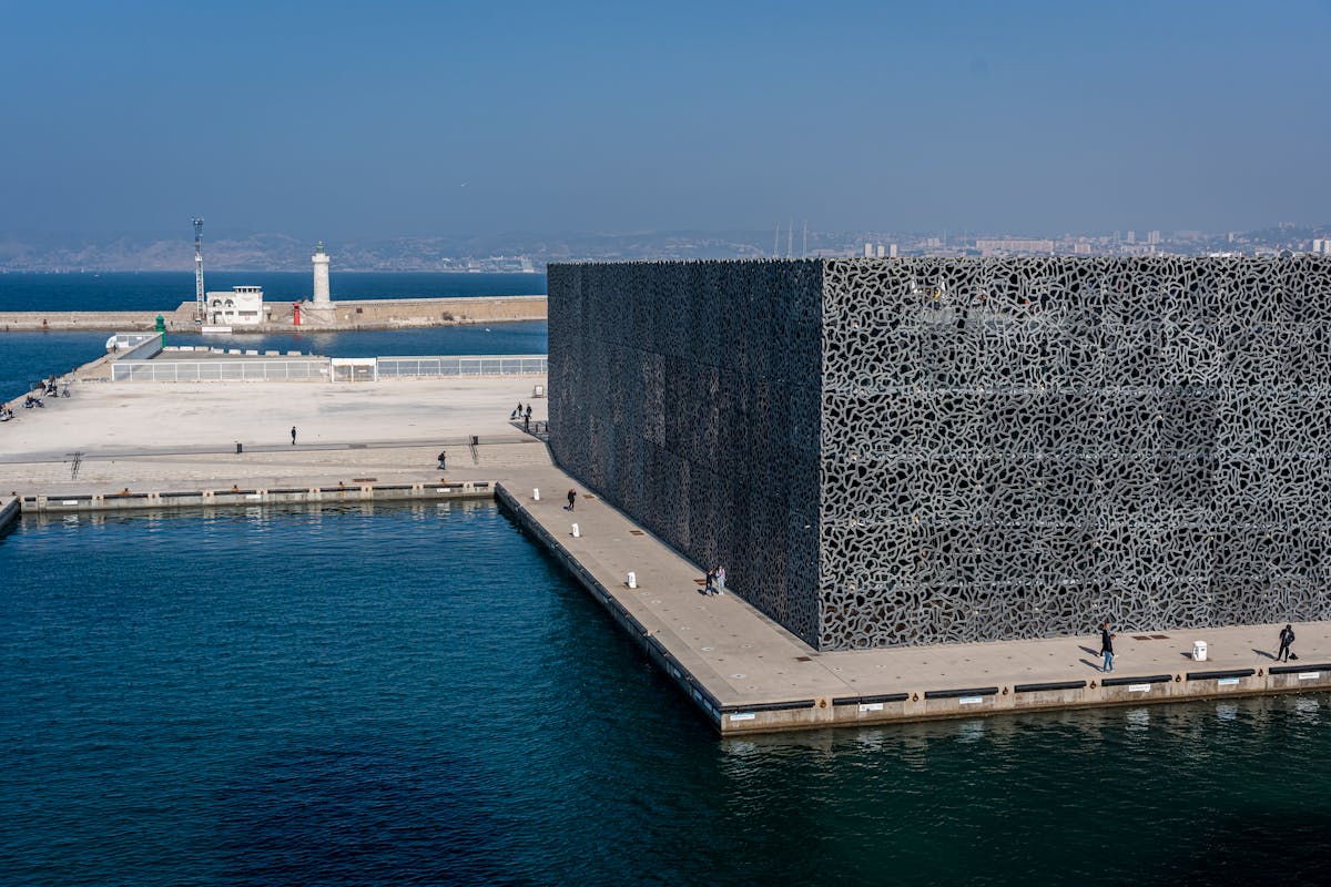 MuCEM museum exterior in Marseille featuring modern latticed concrete architecture by the sea