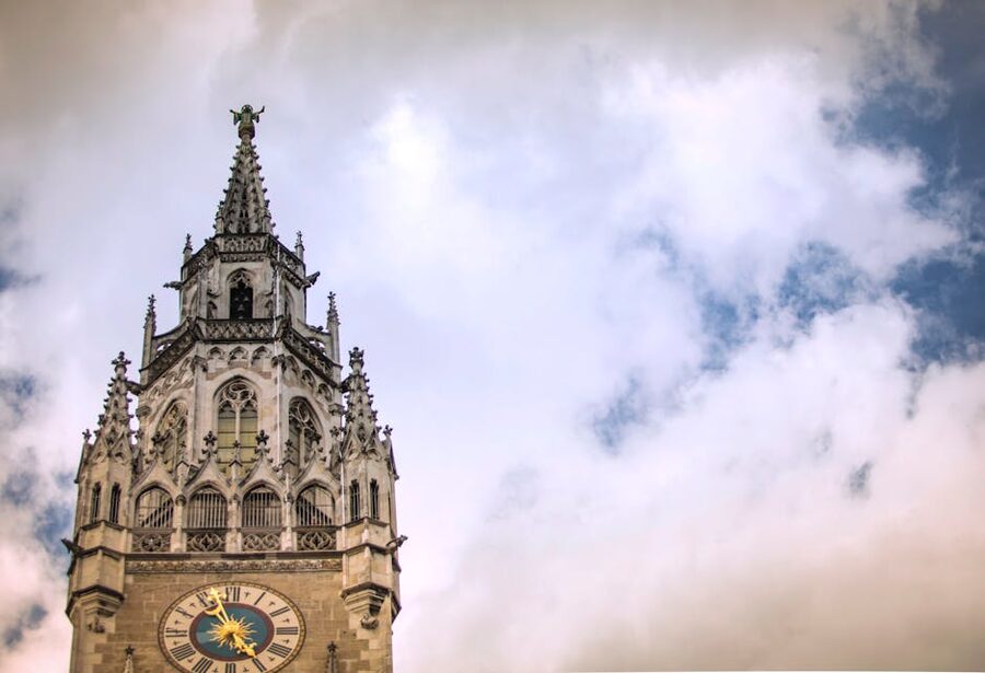 Munich Gothic clock tower with dramatic clouds