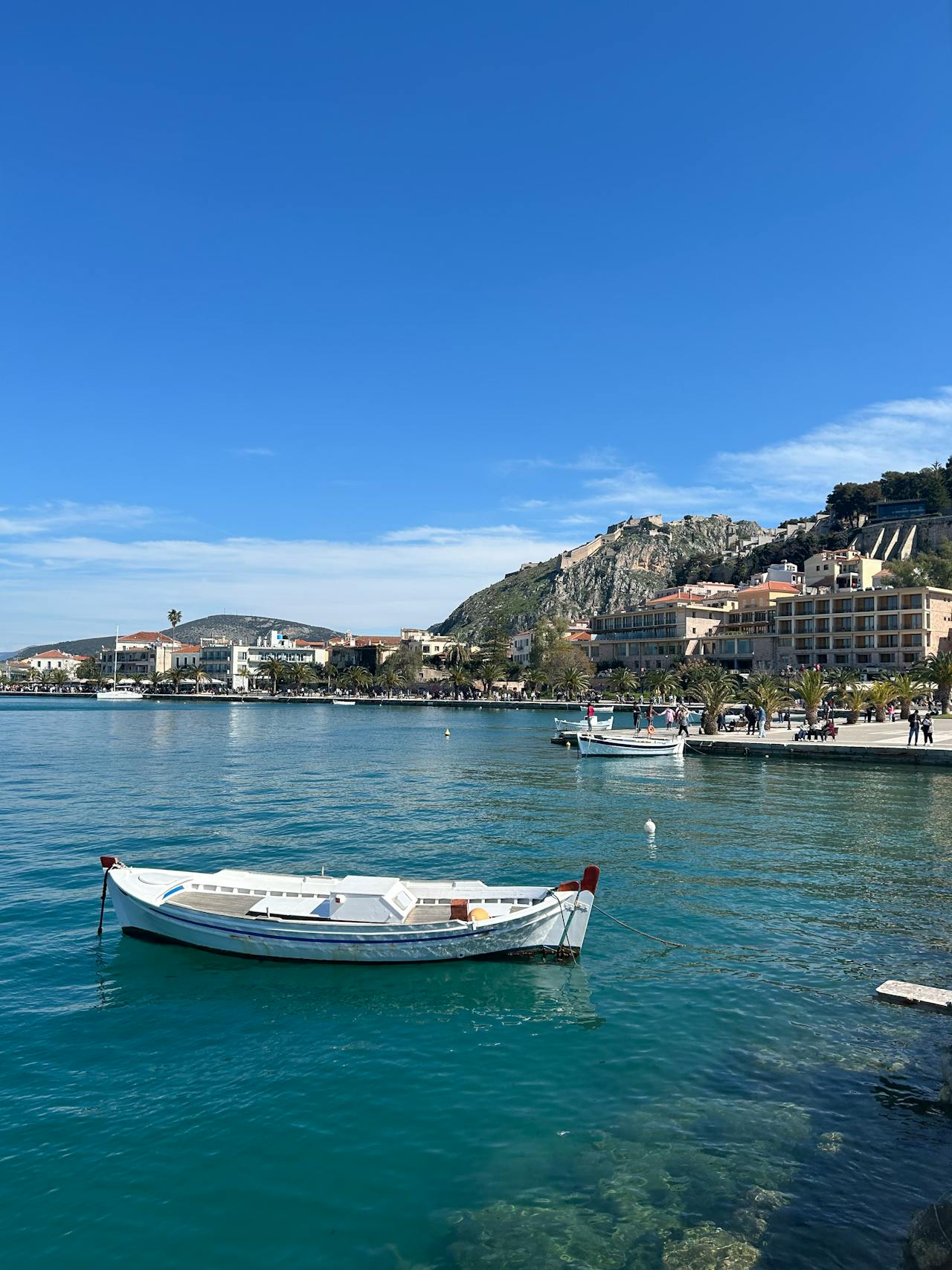 Coastal view of Nafplio with clear blue waters and rocky shoreline