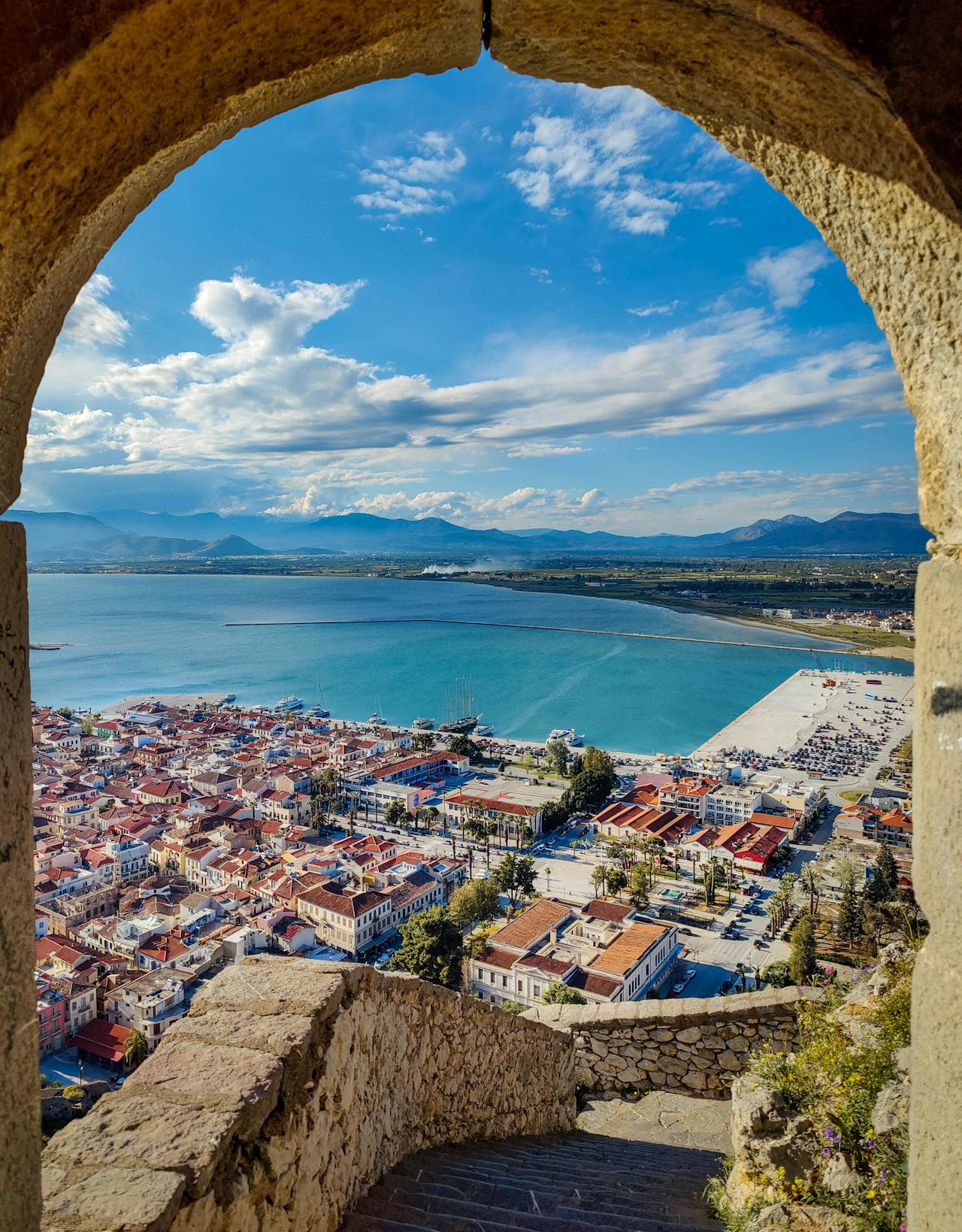 View of Nafplio harbour with boats and the Bourtzi fortress visible in the bay