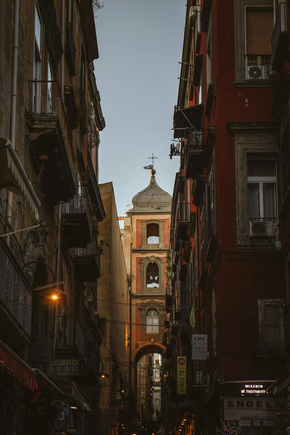 Quiet historic alleyway with old buildings in Naples Italy at dusk