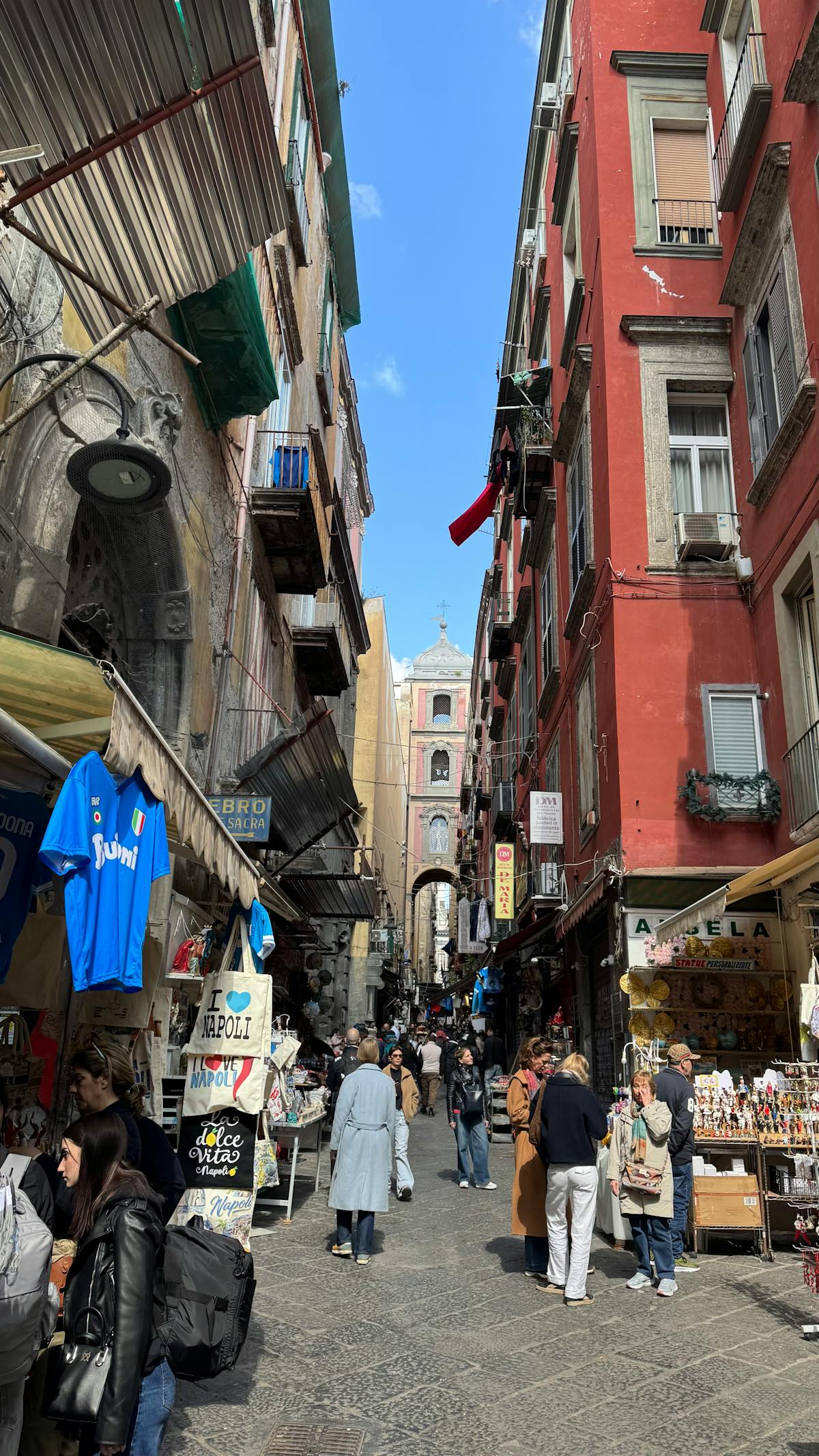 Busy street market in Naples with colorful buildings