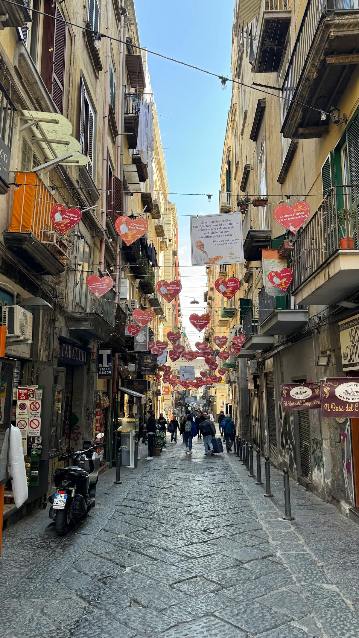 A picturesque street in Naples adorned with heart decorations