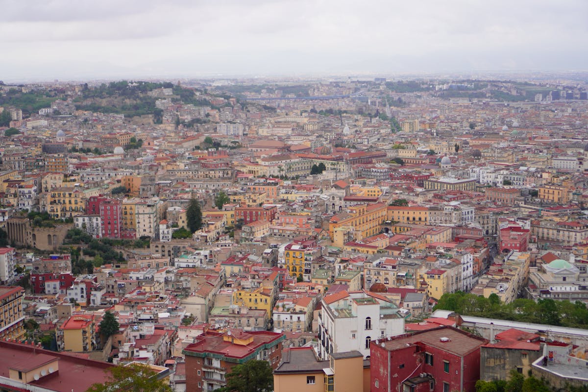 Dense rooftops and historic buildings in Naples Italy under overcast sky