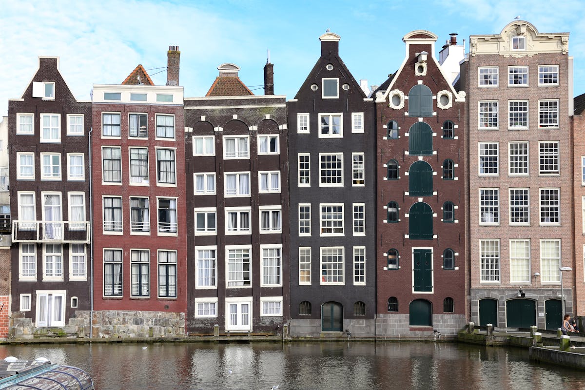 Scenic narrow canal houses in Amsterdam showing unique architecture