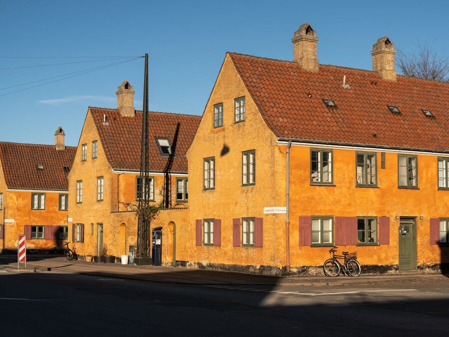 Charming yellow houses with red roofs in Copenhagen Denmark historic neighborhood