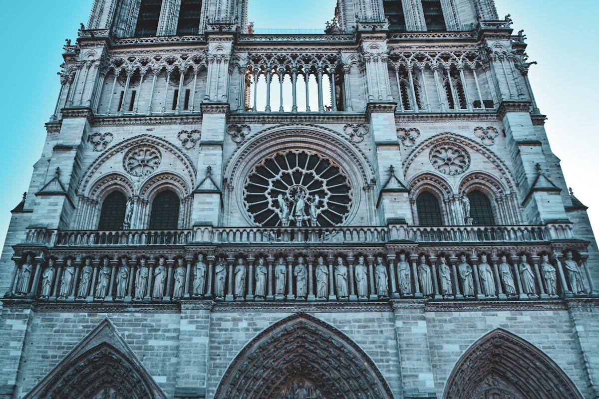 Close-up view of stone statues and Gothic carvings on the facade of Notre-Dame Cathedral in Paris