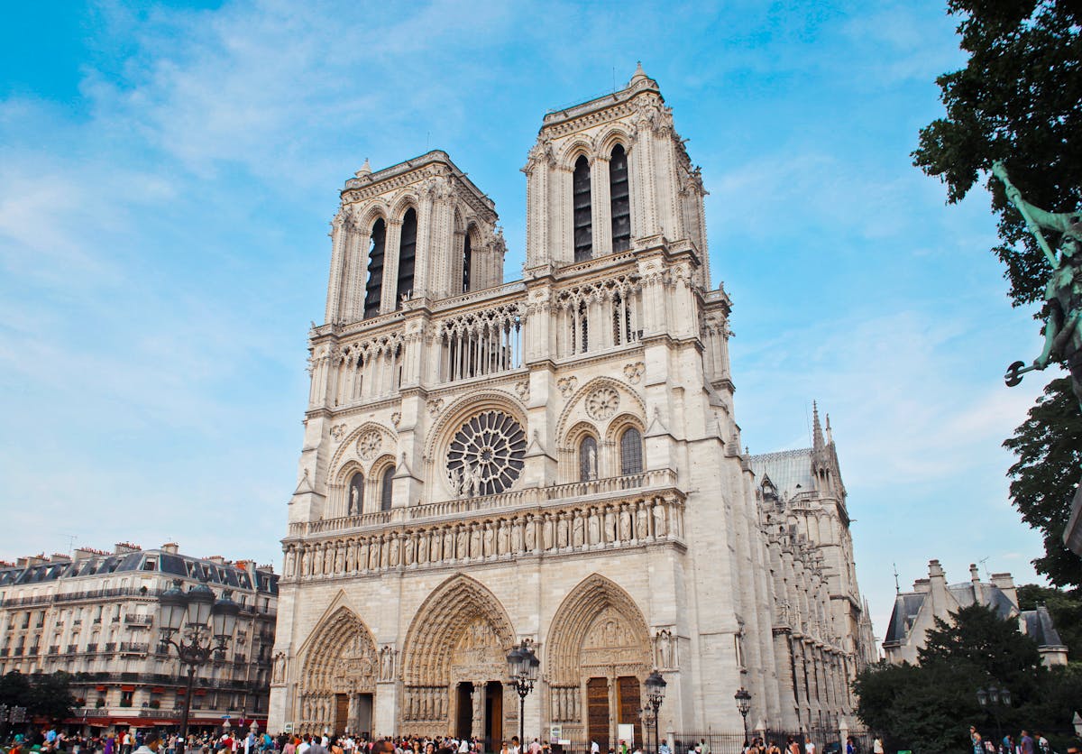 Notre-Dame Cathedral in Paris with crowds of visitors on the square in front of the cathedral