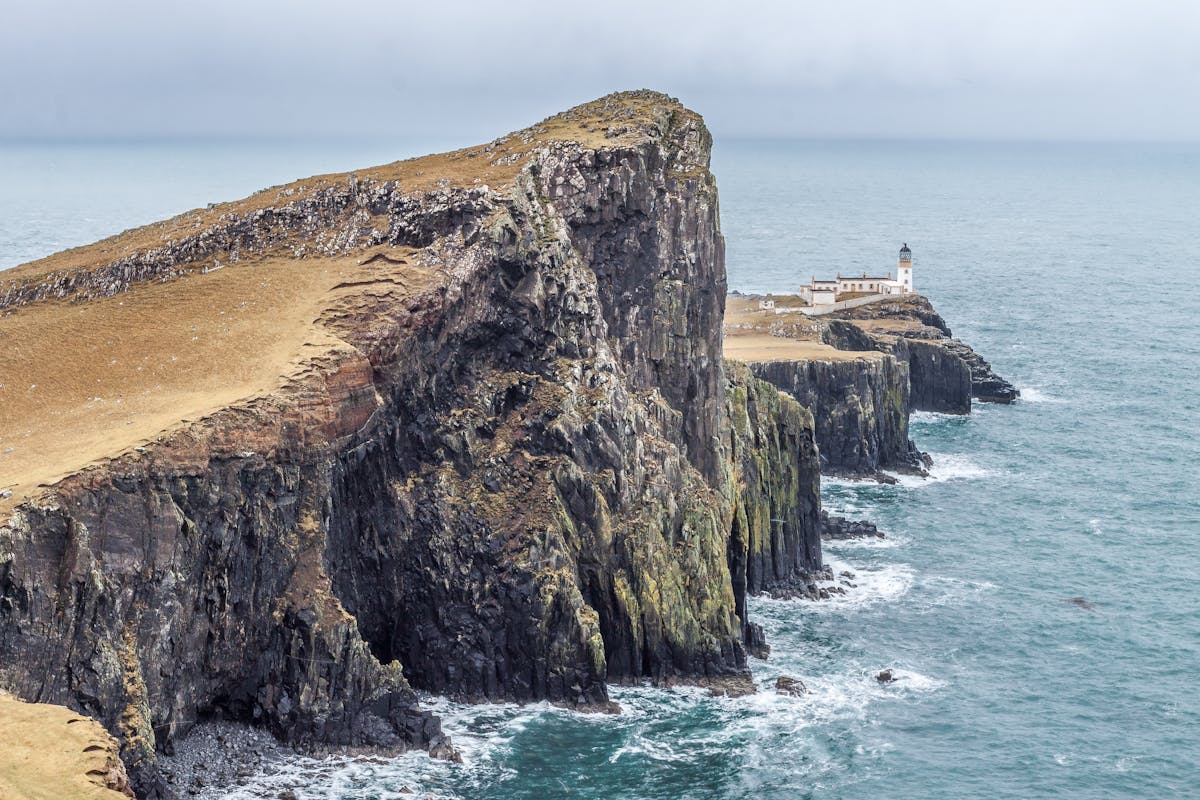 Neist Point Lighthouse perched on dramatic cliffs on the Isle of Skye coastline