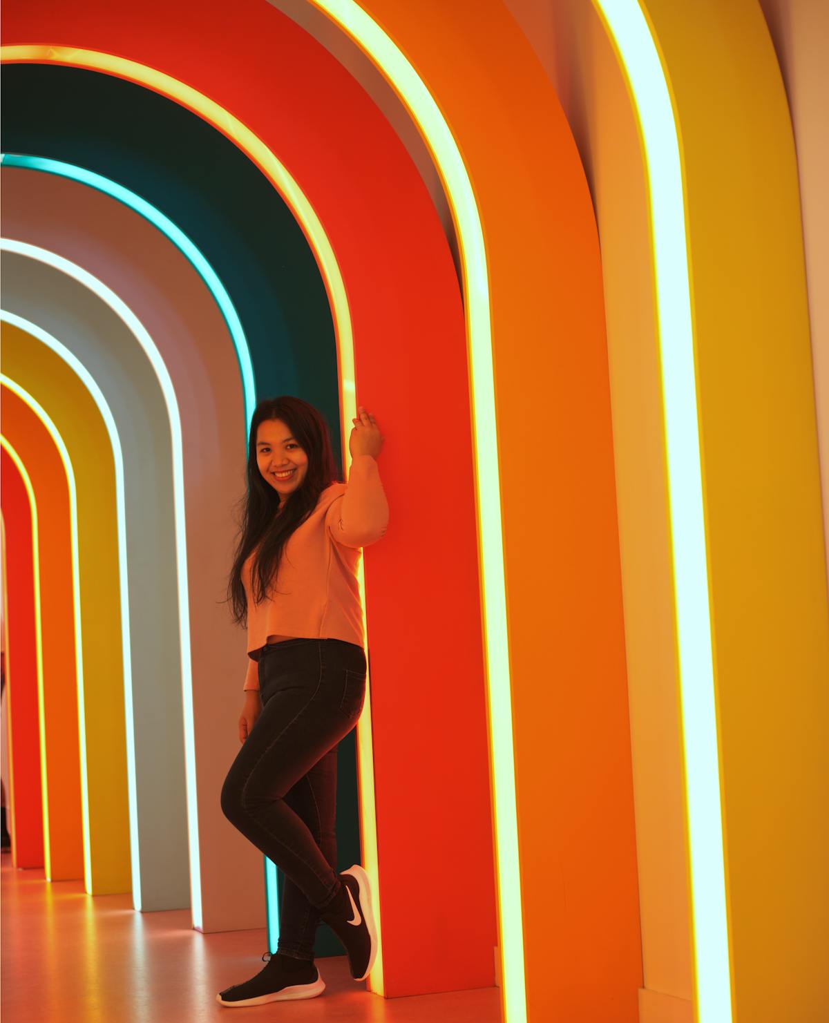 Portrait of woman under neon arches