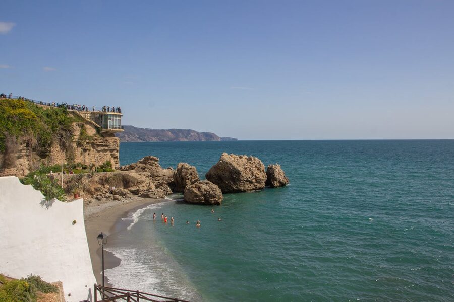 The Balcon de Europa viewpoint in Nerja overlooking a sandy beach and rocky coastline