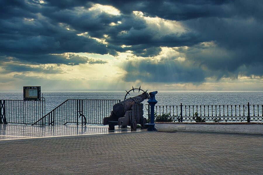 An old cannon on the Balcony of Europe viewpoint in Nerja with the sea behind