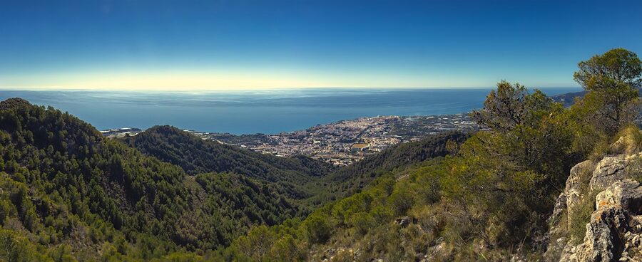 Wide panorama of the Nerja coast showing beaches, cliffs, and the Mediterranean