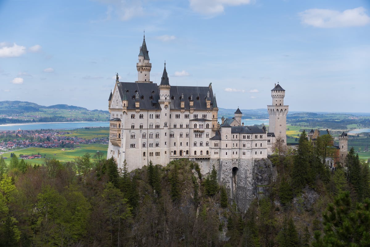 Neuschwanstein Castle standing against a bright Bavarian landscape on a clear day