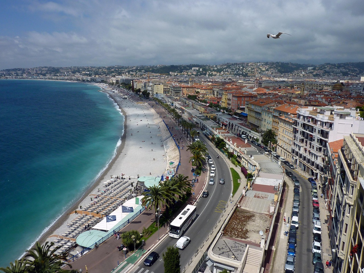 Nice France coastline with turquoise Mediterranean water and beach umbrellas