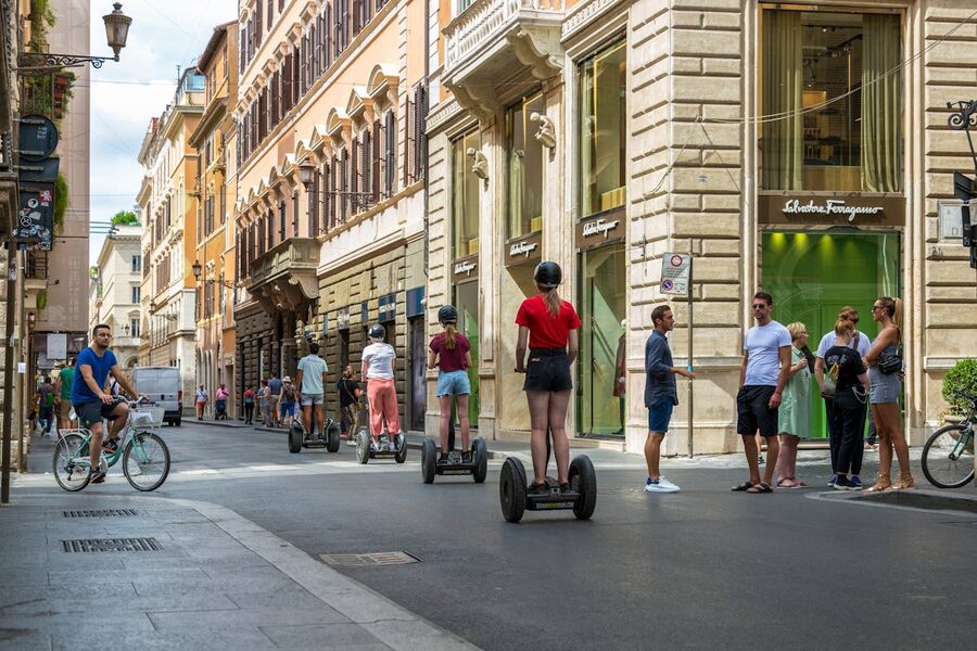 Group of people riding Segways along a historic cobblestone street