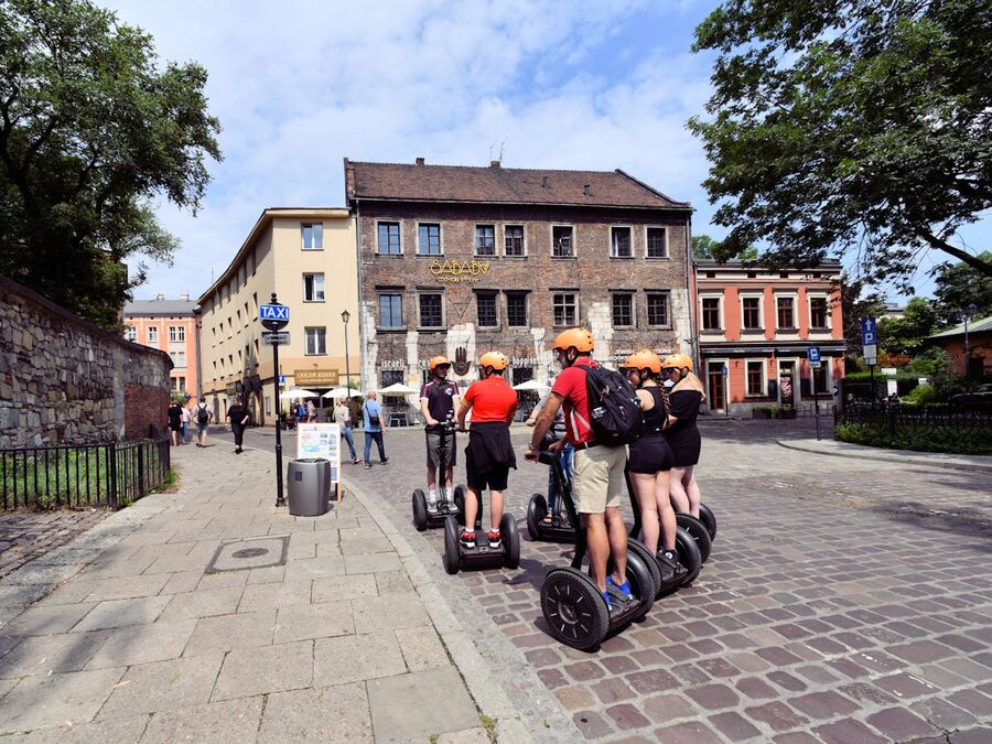 Tourists on Segways touring a European city with cobblestone streets