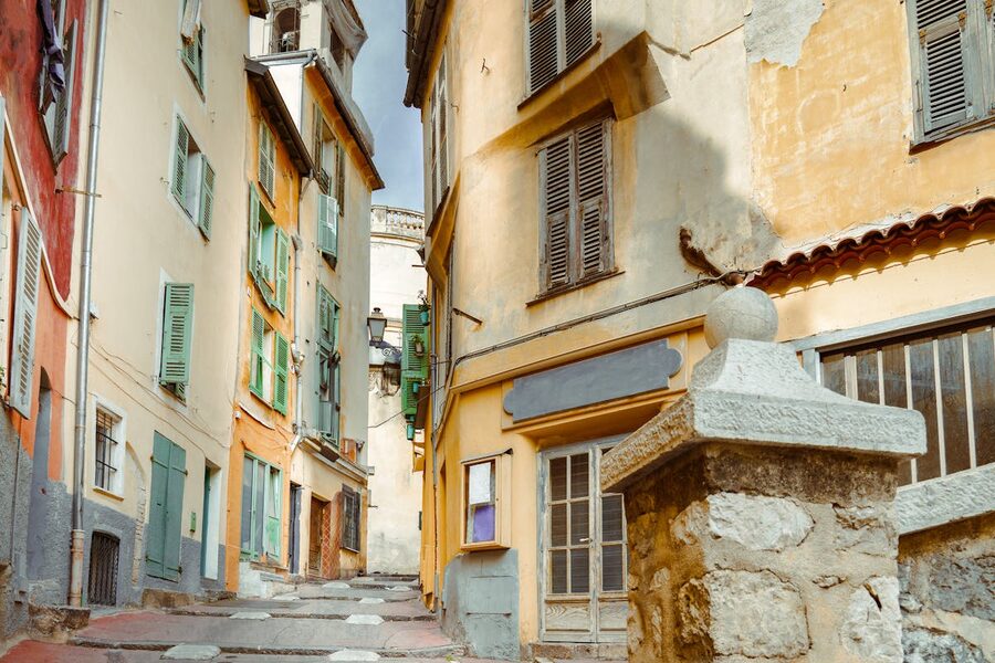 Charming narrow street in Nice old town with historic French architecture