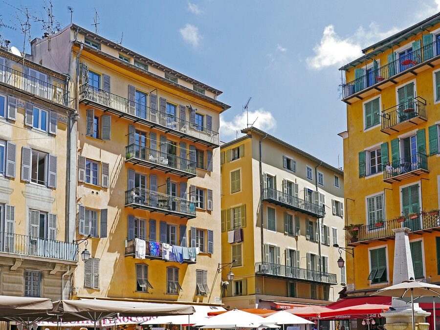 Historic marketplace with colourful facades and umbrellas in Nice old town