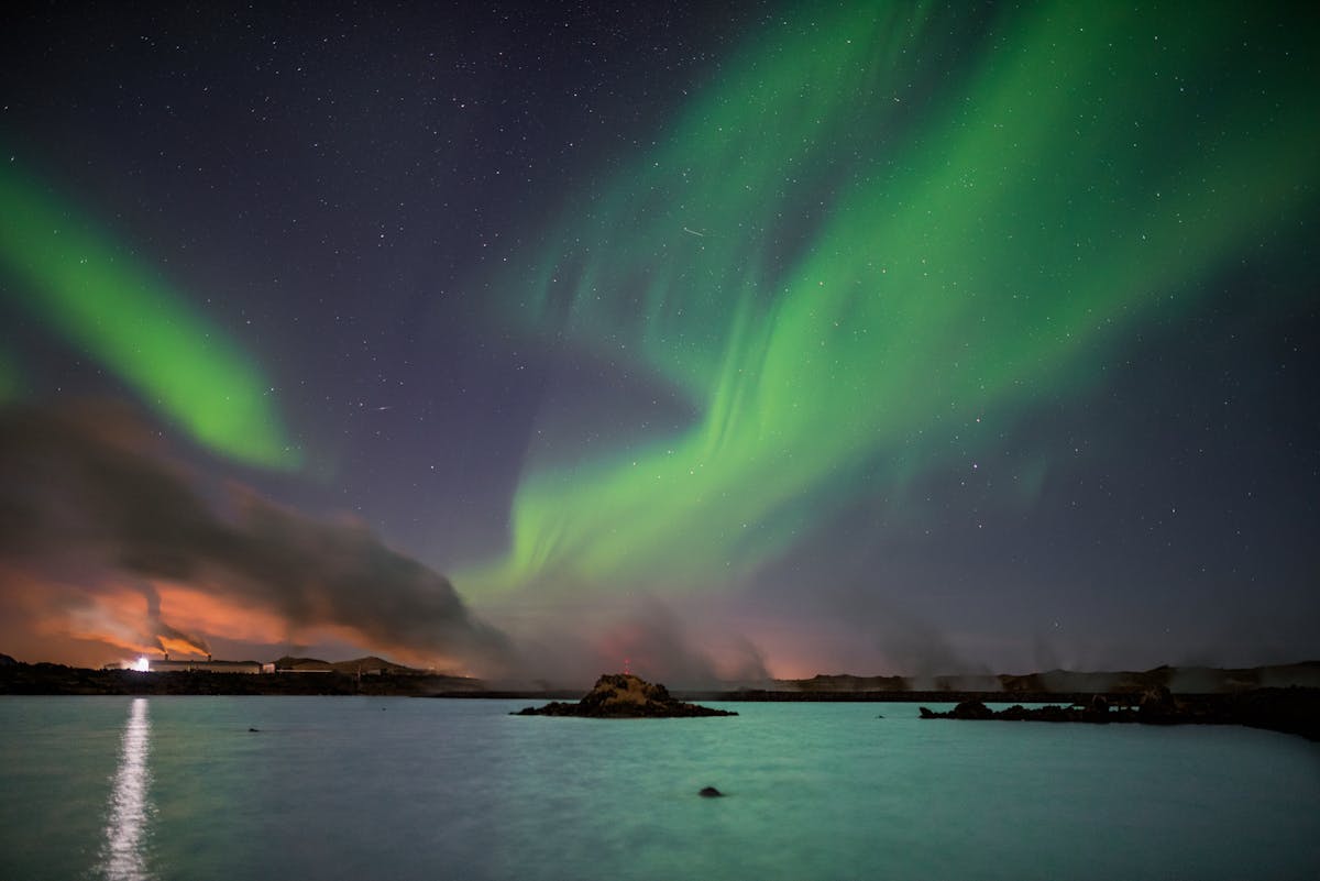 Aurora borealis reflecting on a lake near Keflavik Iceland