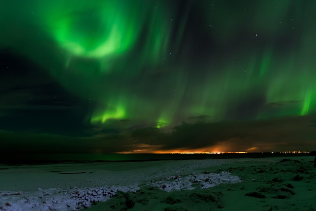Bright green aurora borealis illuminating the Iceland night sky