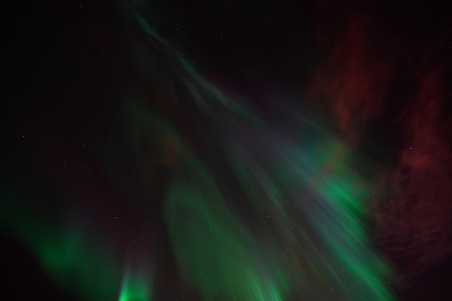 Stars and green aurora filling the Iceland night sky