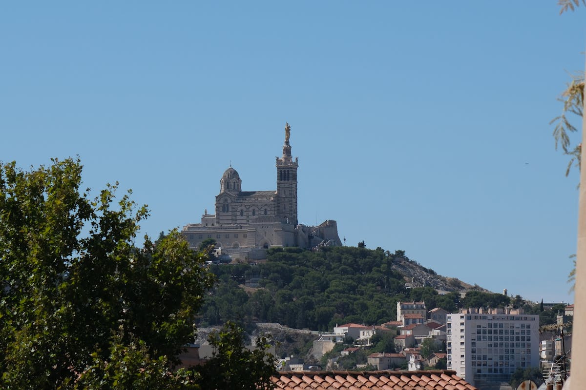 Notre-Dame de la Garde basilica on a hilltop in Marseille under clear blue sky