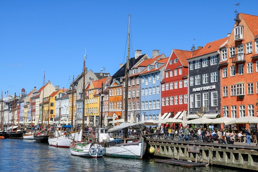Panoramic view of Nyhavn harbor with boats and colorful buildings in Copenhagen