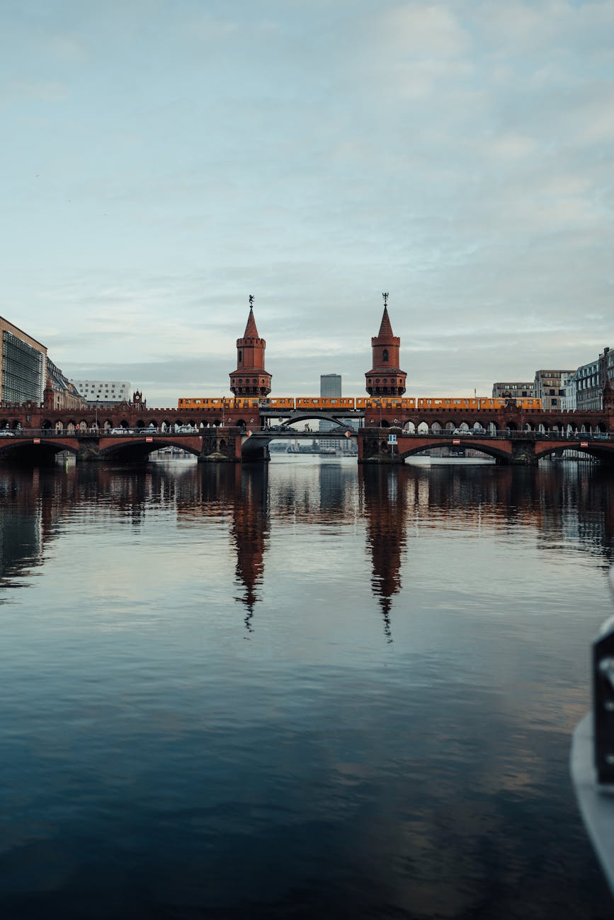 Oberbaum Bridge reflected in the calm Spree River at dusk