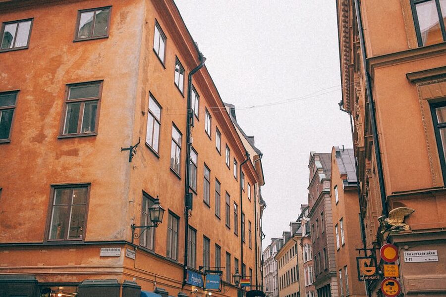 Aged red residential buildings on a narrow curving street in Gamla Stan Stockholm