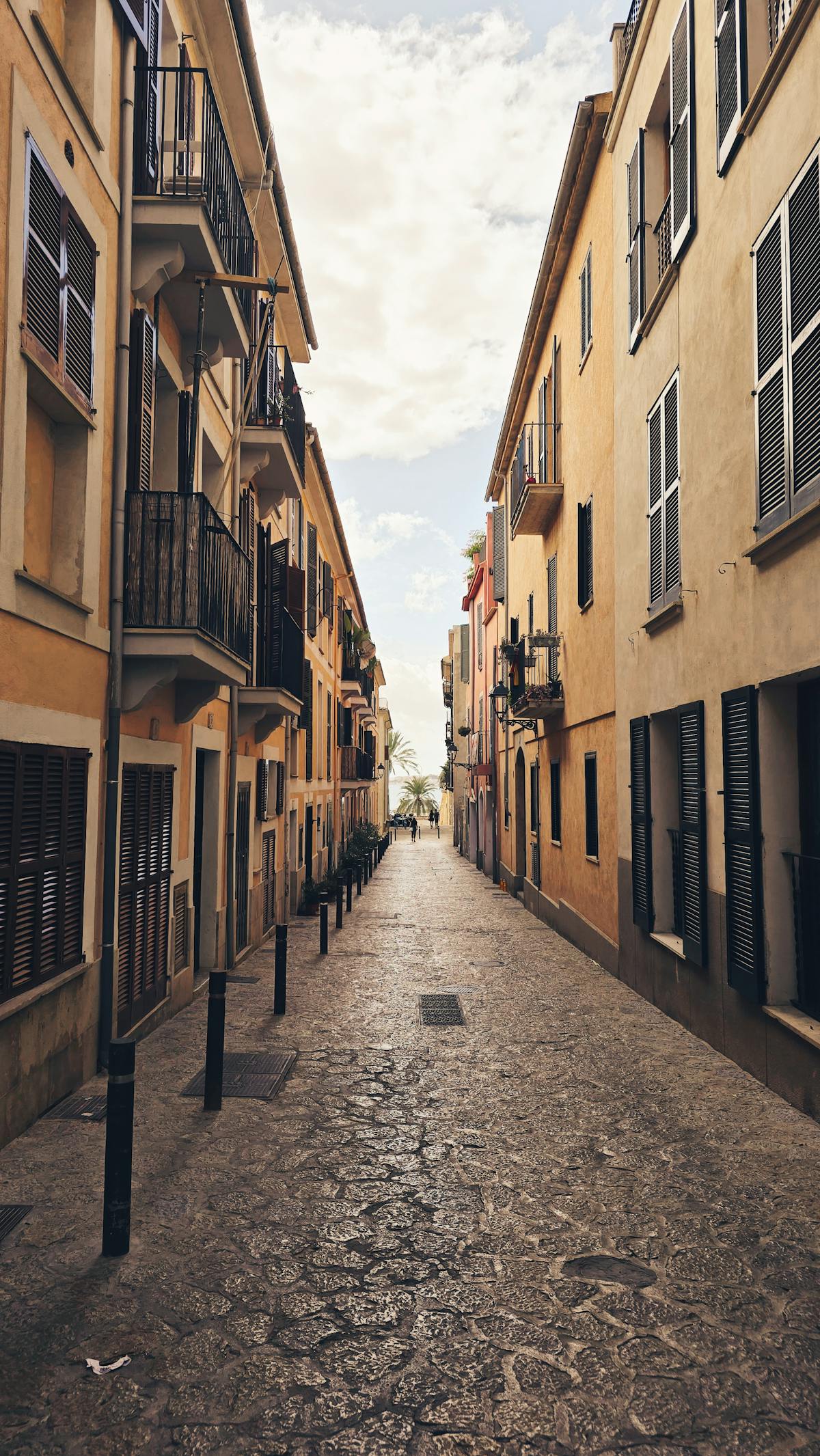 Picturesque street in Palma de Mallorca old town with traditional Spanish sandstone architecture and balconies
