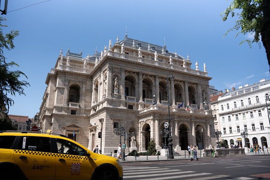 Budapest Opera House street view with yellow taxi