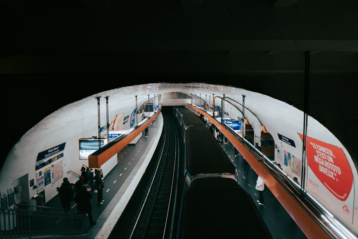 Paris Metro station with passengers and train