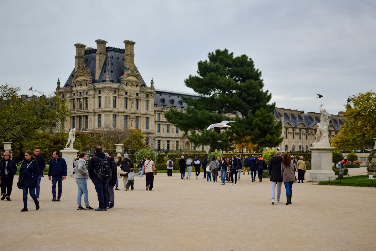 People strolling through Tuileries Garden in Paris