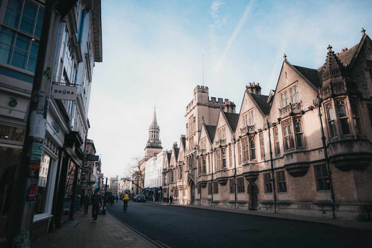 Historic Oxford street with golden sunrise light on stone buildings