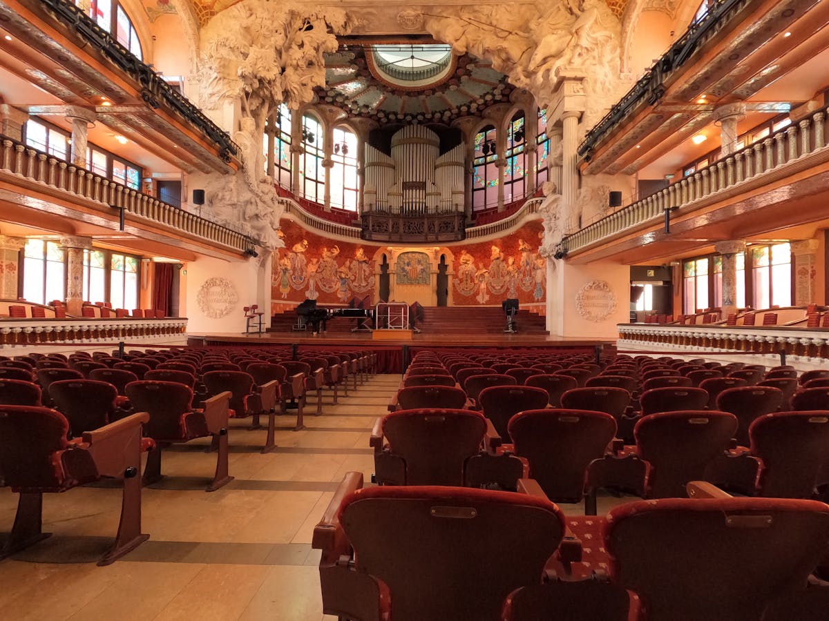 Elegant interior spaces of Palau de la Musica Catalana with arched windows and Modernista flourishes