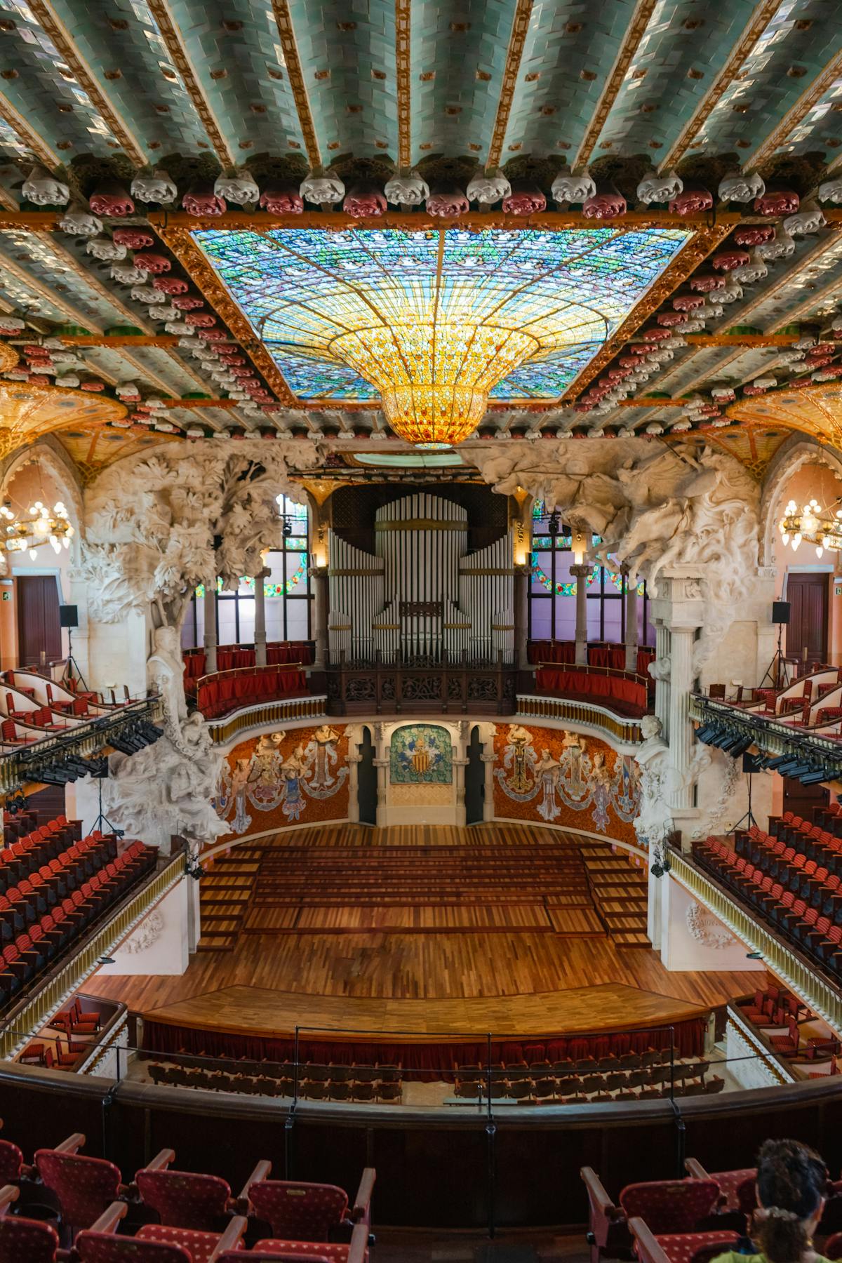 The ornate exterior facade of Palau de la Musica Catalana with its detailed sculptures and mosaic columns