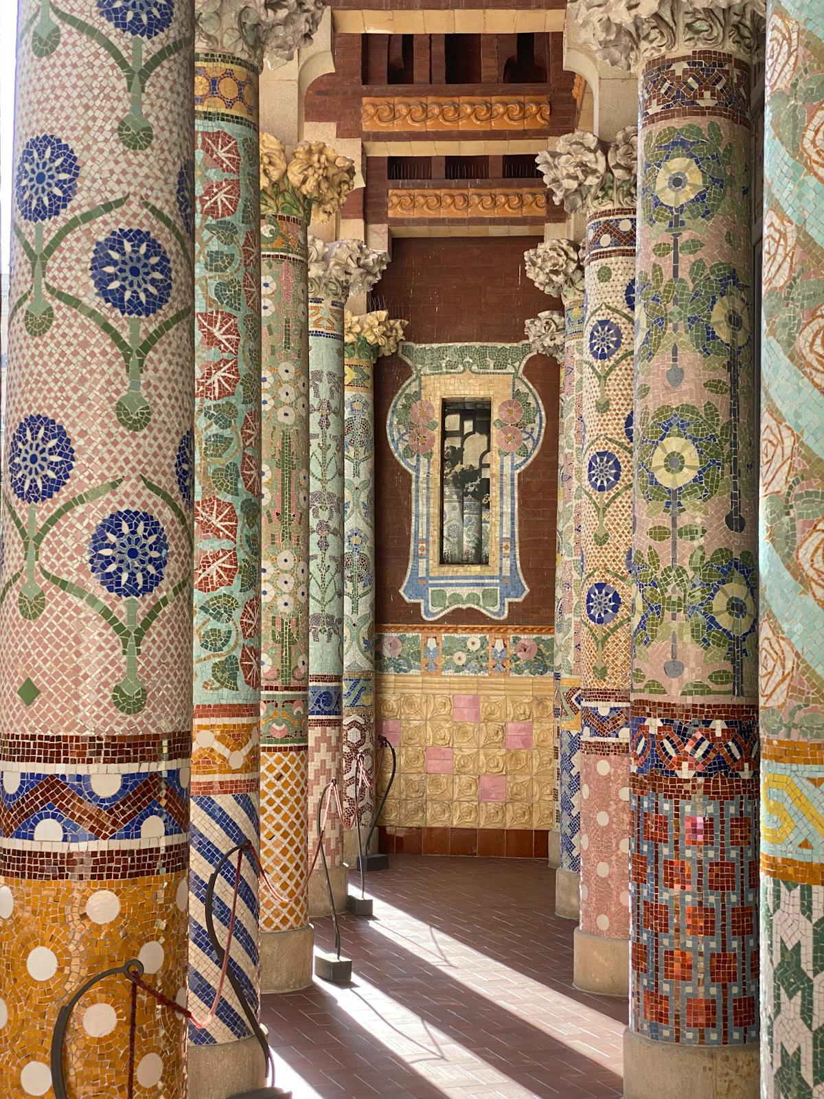 Colourful mosaic columns at Palau de la Musica Catalana with detailed ceramic tilework
