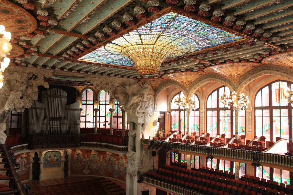 Ornate columns inside Palau de la Musica Catalana decorated with floral ceramic motifs