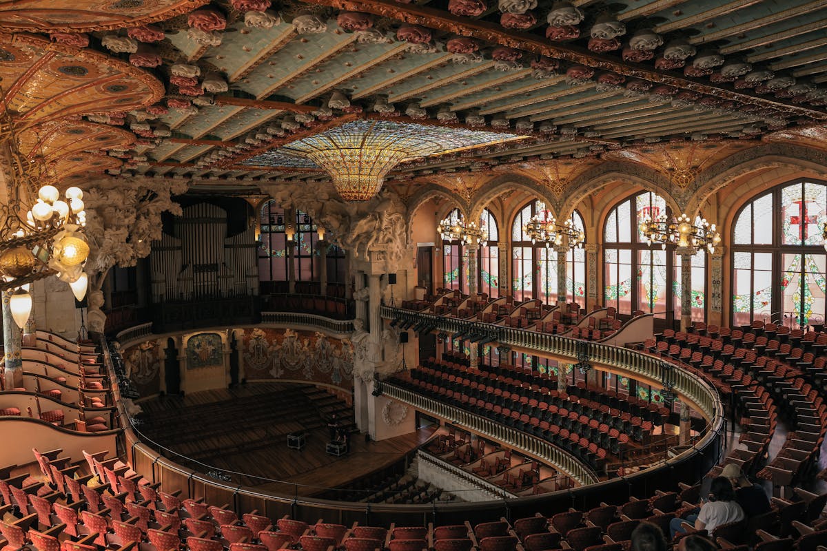 The ornate stage of Palau de la Musica Catalana with its sculptural muses emerging from the back wall