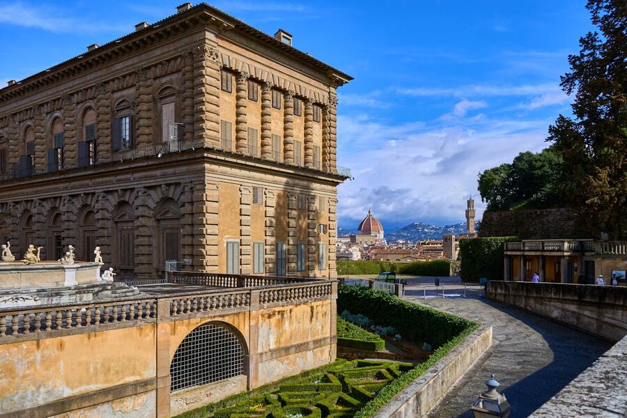 Palazzo Pitti building with Florence Cathedral dome visible in the skyline behind