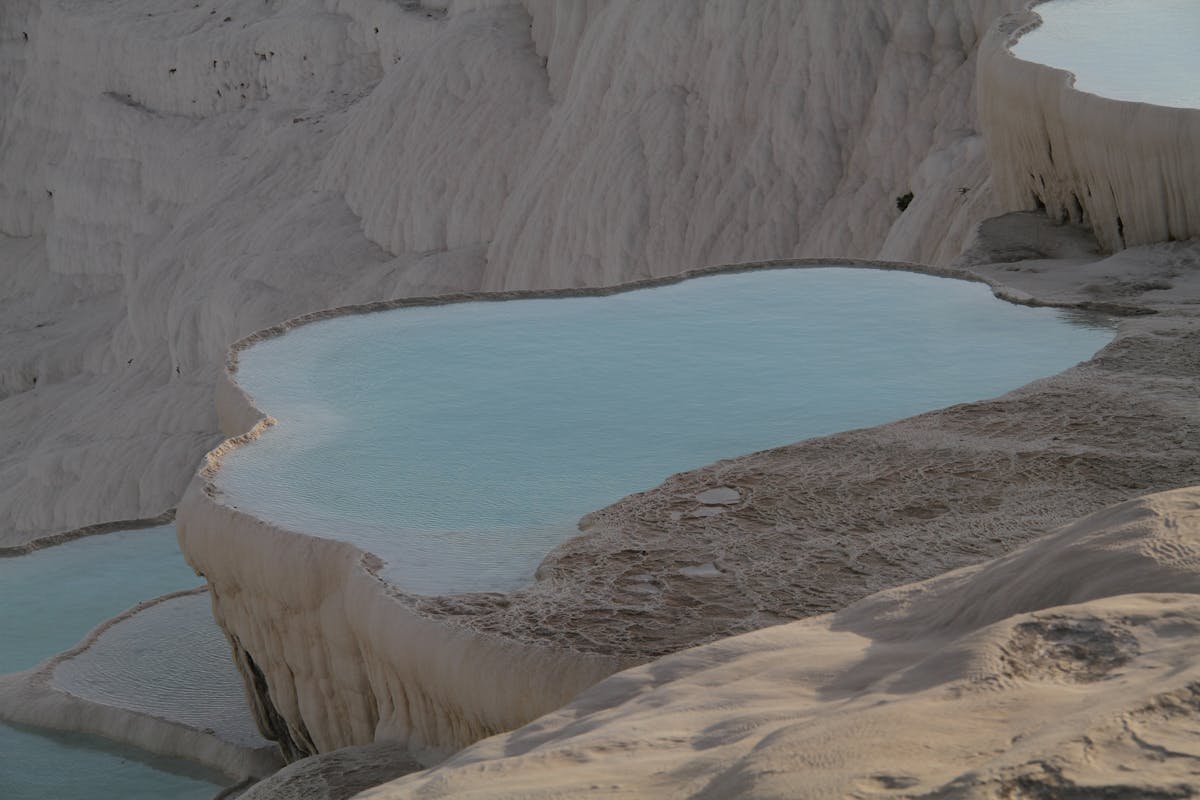 Warm thermal water flowing over white calcium formations at Pamukkale