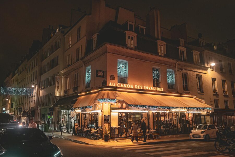 Cozy evening scene at a Parisian cafe with warm lighting