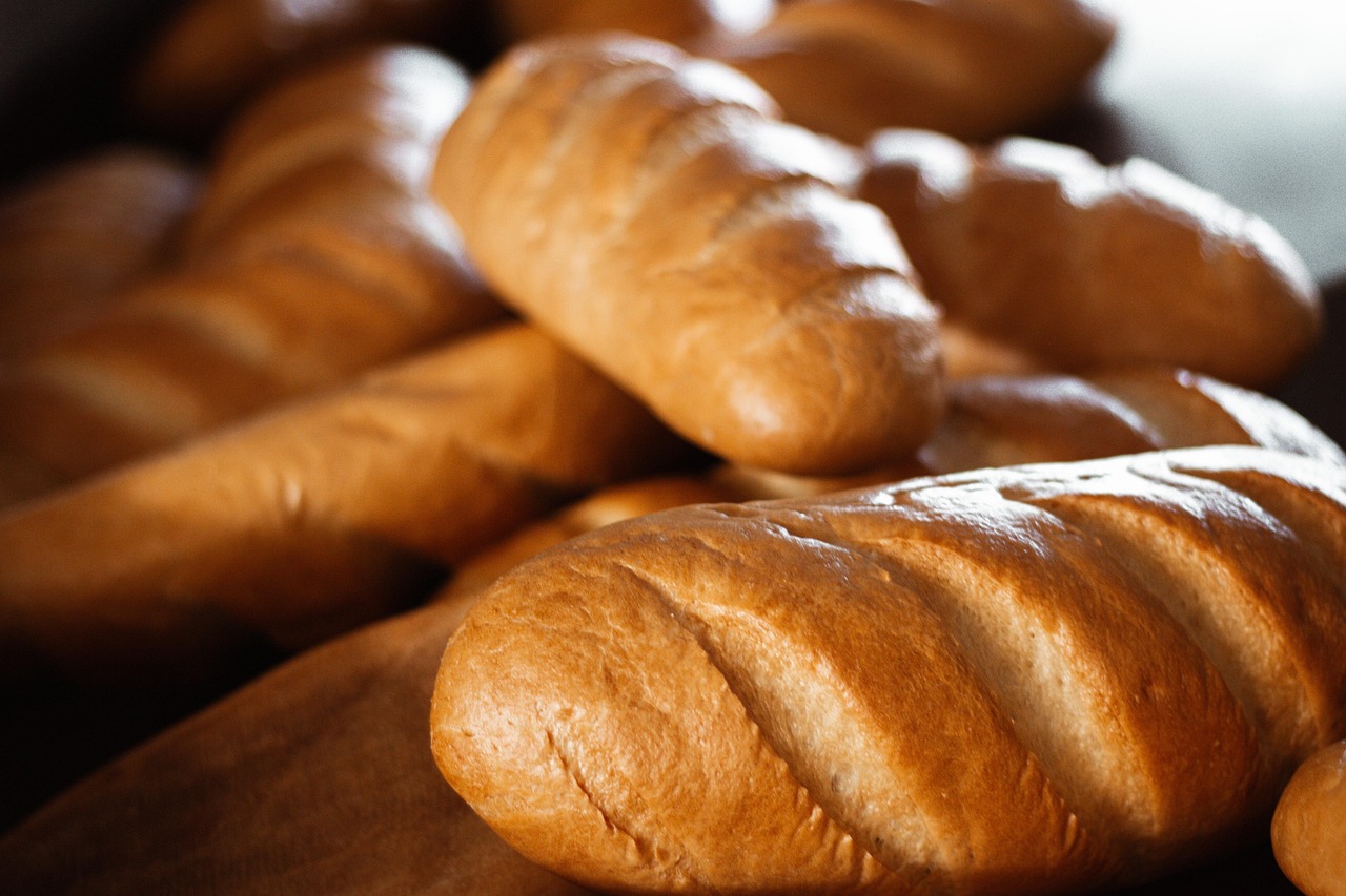 Freshly baked French baguettes stacked in a bakery