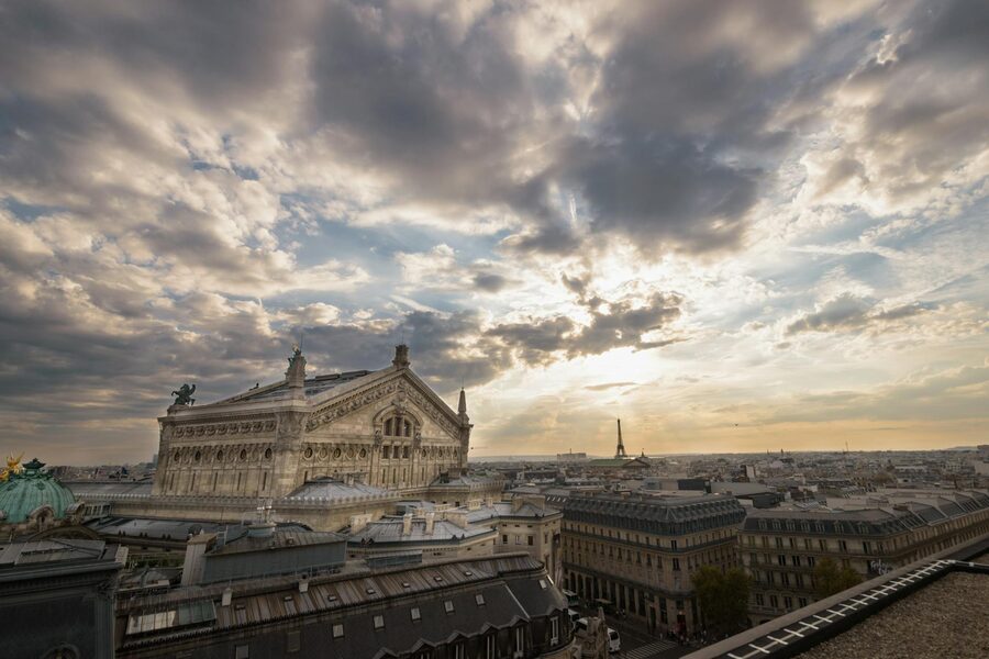 The Palais Garnier opera house in Paris with its ornate facade and surrounding boulevard