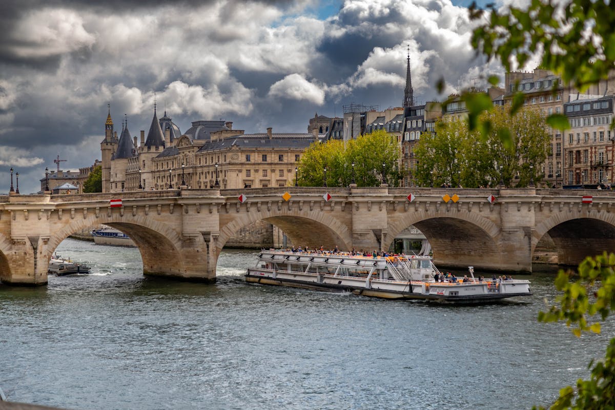 Scenic view of Pont Neuf bridge and cruise boat on the Seine in Paris