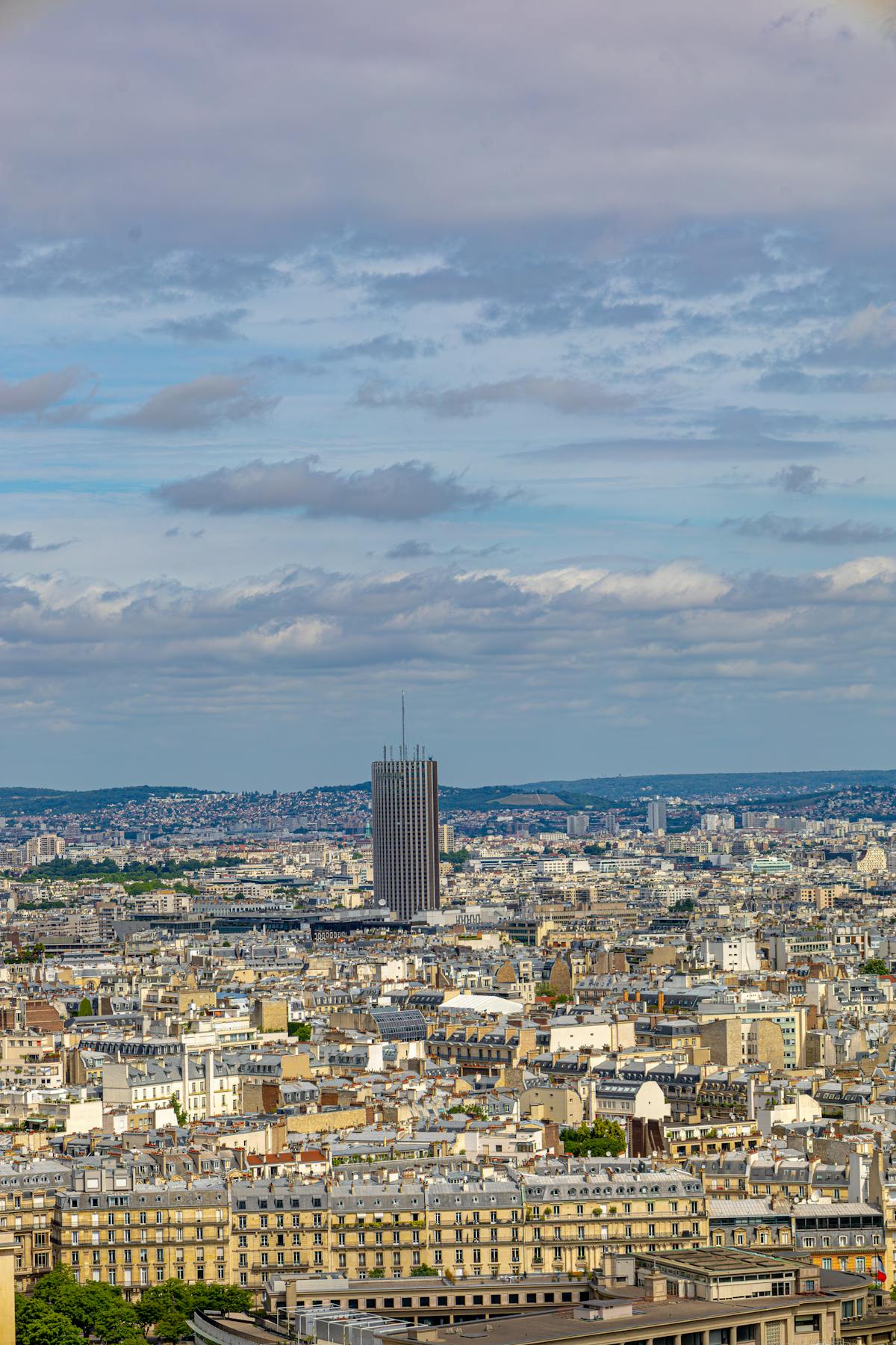 Aerial shot of the Paris skyline with the Montparnasse Tower prominent against the sky