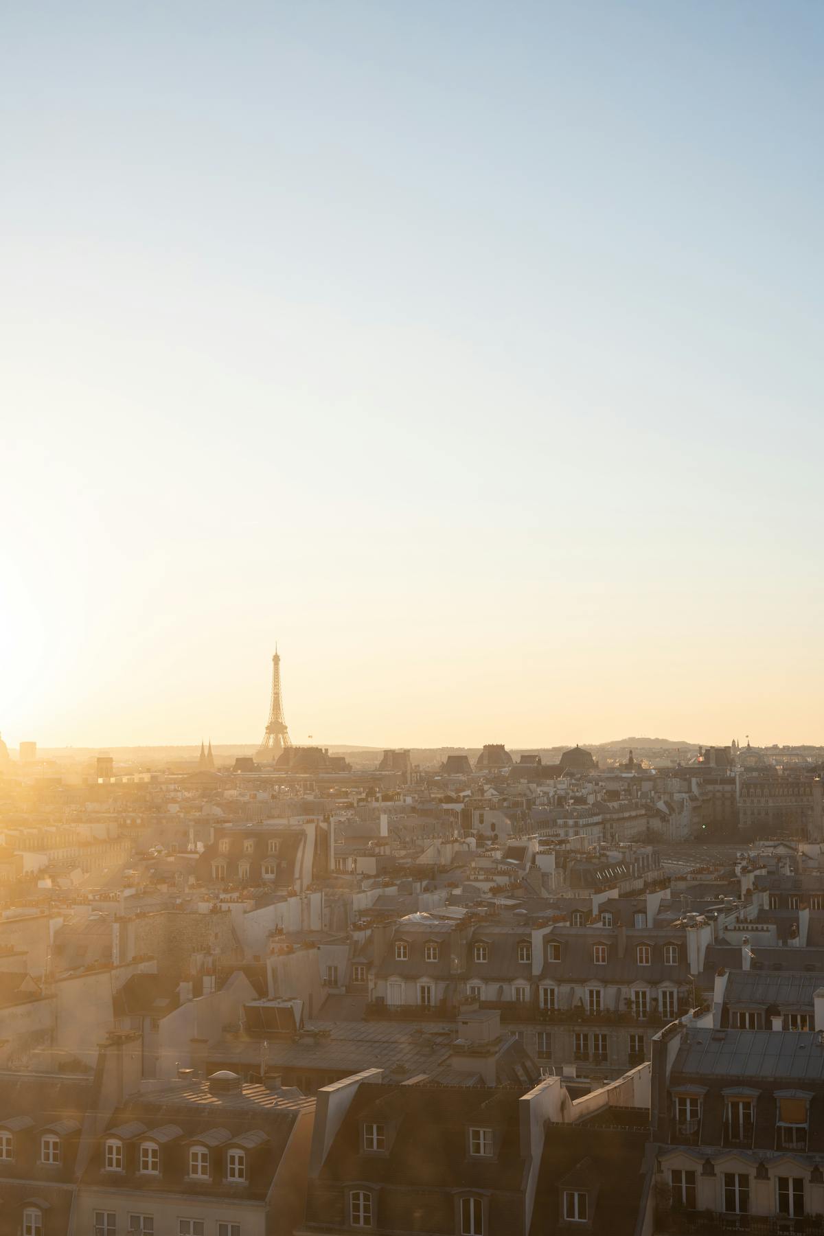 Aerial view of the Eiffel Tower at golden hour with the Seine River winding below