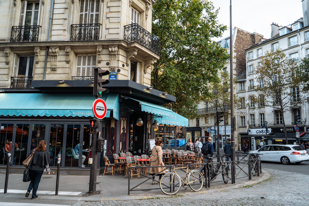 Scenic Paris cafe on a cobblestone street corner with classic architecture